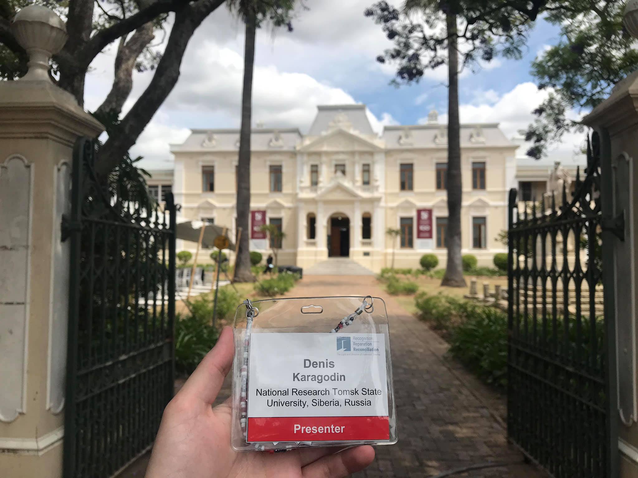 Denis Karagodin holding his presenter badge at Stellenbosch University, South Africa.