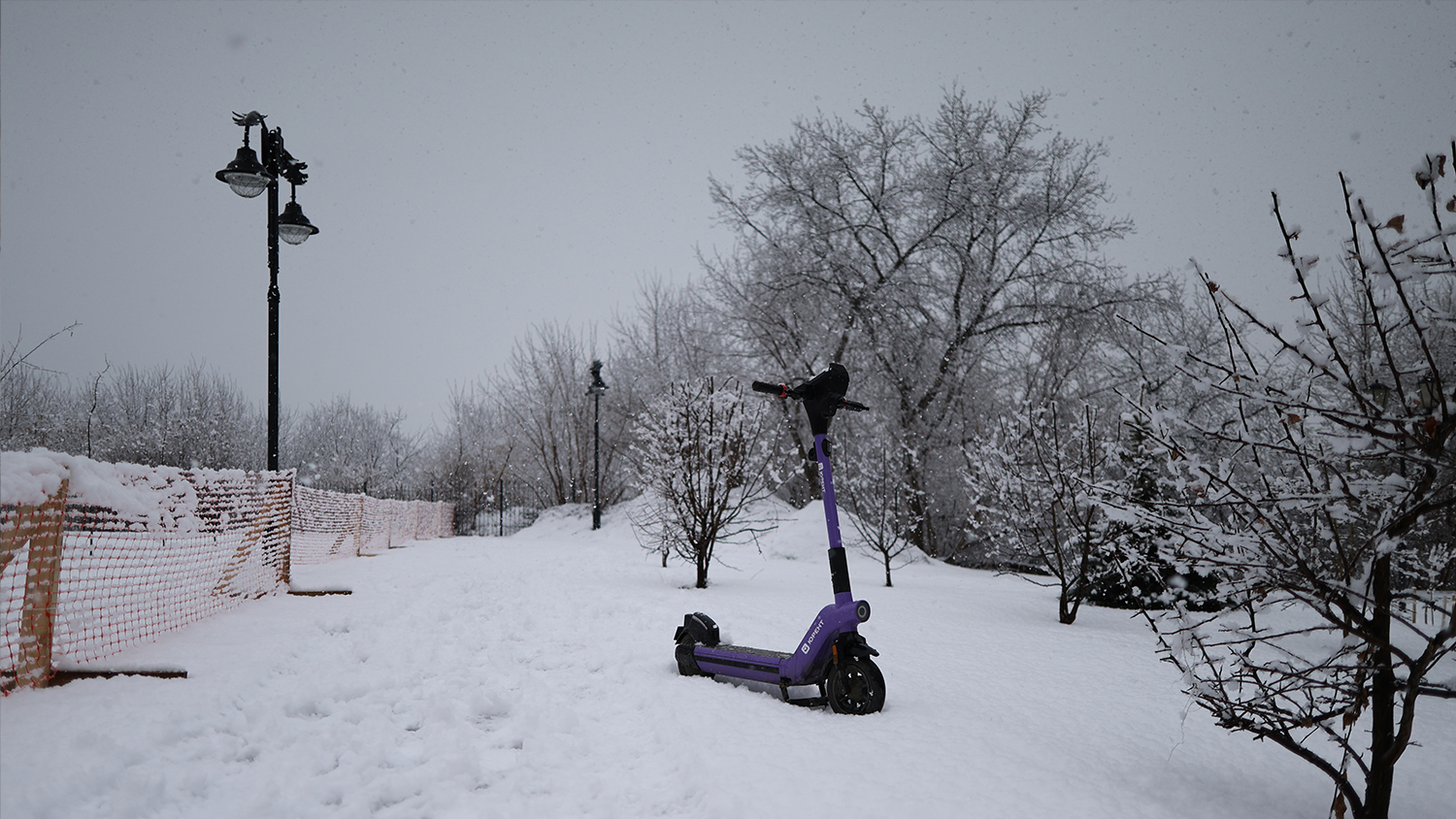 An electric scooter stuck in the snow at the site of the dismantled memorial.